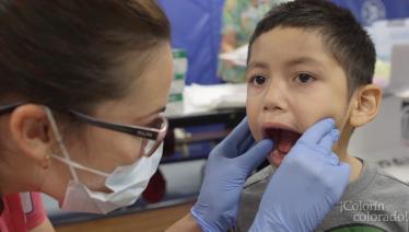 Dental student examining young boy
