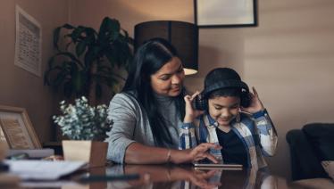 Mother with son listening to headphones