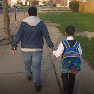 Older brother walks with younger brother