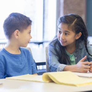 Two young students talking