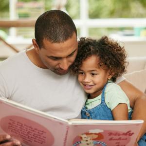 Father reading with daughter